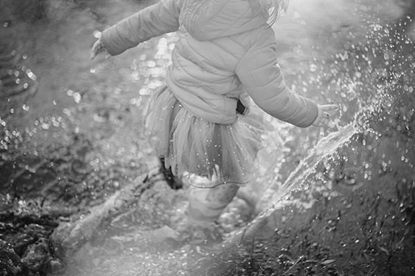 Child spashing through puddle