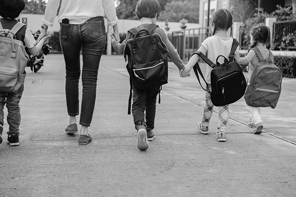 Children walking to school with adult