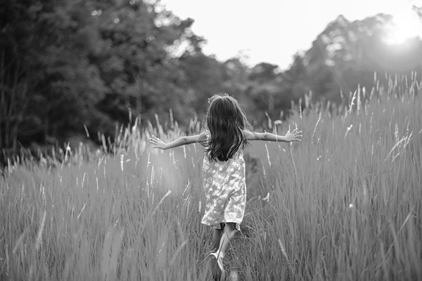 Child walking through field